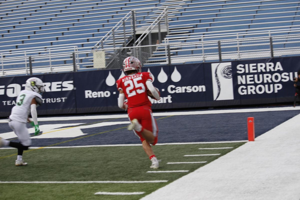 Junior Joe Birnbaum rushes for a touchdown during Truckee's 35-14  victory over SLAM Academy for the 2023 Nevada State Championship.