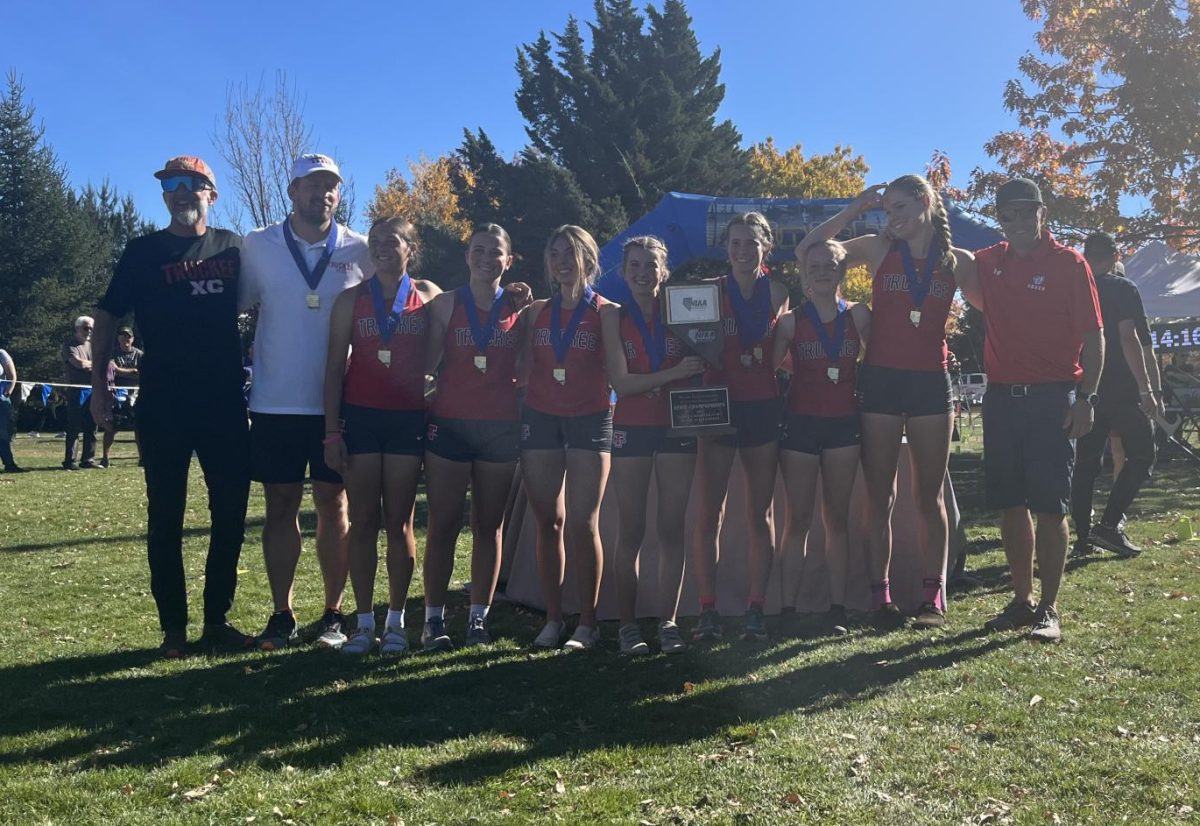 The THS Girls Cross Country team after winning the Nevada State Championship. From left to right, Geoff Quine, Straten Schemel, Ava Cockrum, Natalie Hanley, Peyton Rothery, Sidney McIntosh, Jillian Chalstrom, Adeline Purvance Rassuchine, Jayna Palmer, Rob McClendon