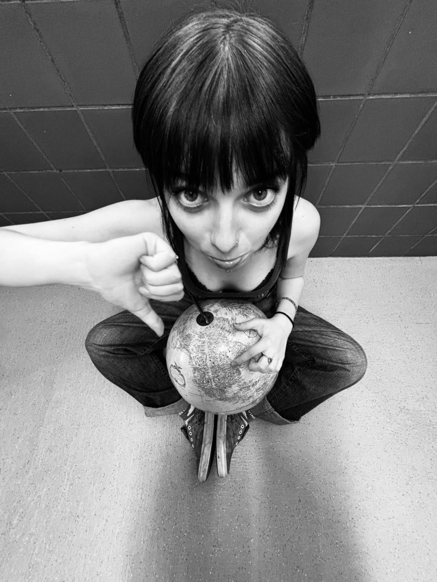 Dani Mason points to America with disapproval.